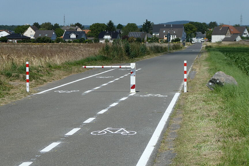Schranke Berkumer Weg Das Bild zeigt eine neu installierte Schranke auf dem Berkumer Weg, die in Zukunft den Autoverkehr stoppt und einen ungefährdeten Radverkehr erlaubt.